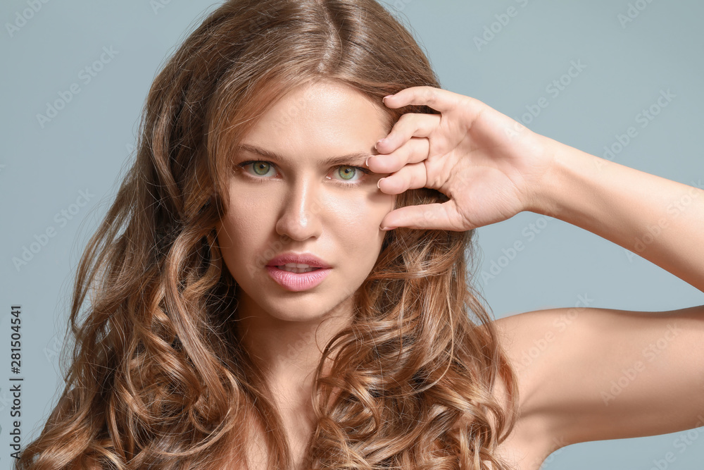 Fototapeta premium Beautiful young woman on color background