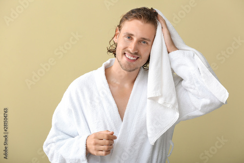 Handsome man wiping hair af...