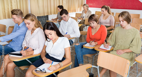 Woman listening to lecture in classroom