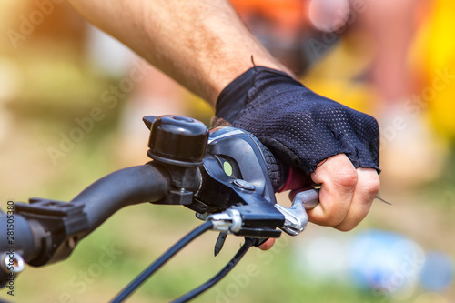Cycling. Men's hands hold the brake on the handlebar of the bike.