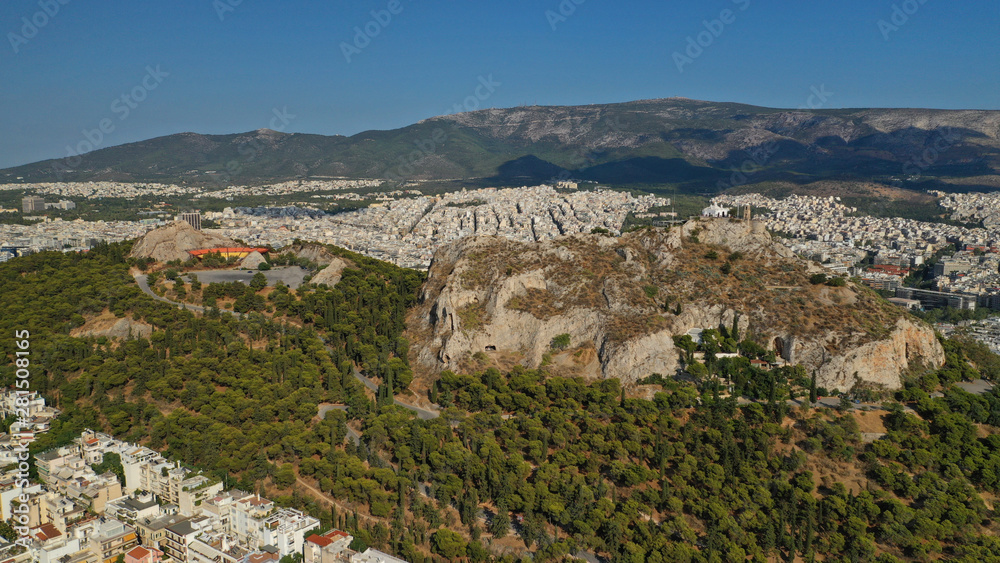 Aerial drone photo of iconic Lycabettus hill and iconic chapel of Saint George on top in cityscape of Athens, Attica, Greece