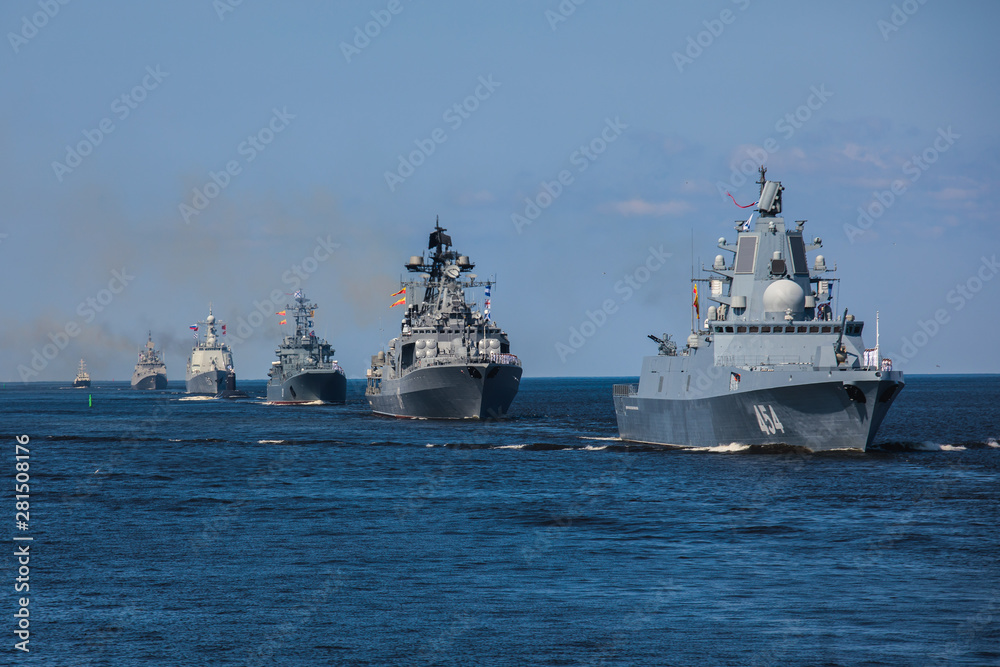 A line ahead of modern russian military naval battleships warships in the row, northern fleet and baltic sea fleet, summer sunny day