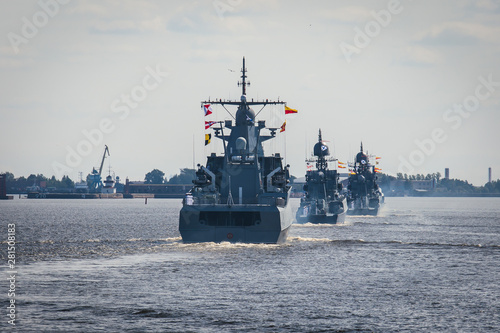 A line ahead of modern russian military naval battleships warships in the row, northern fleet and baltic sea fleet, summer sunny day