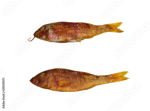 Dried two Mullus fishes on the table. Salty dry  fish on a white background. Dead dry salty fish - snack to beer. Isolated on white. Soft focus