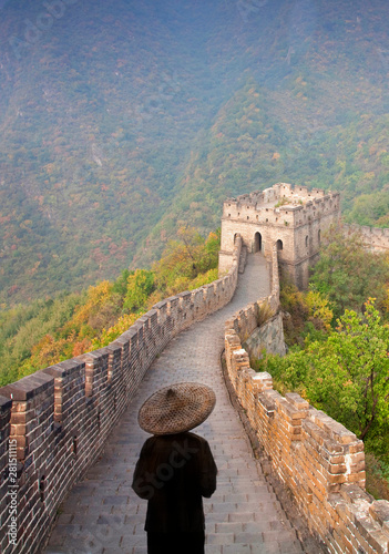 Rear view of man in straw hat standing on Great Wall of China photo