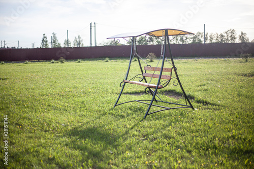 Bench swing for relaxation. Summer shop for joint gatherings.