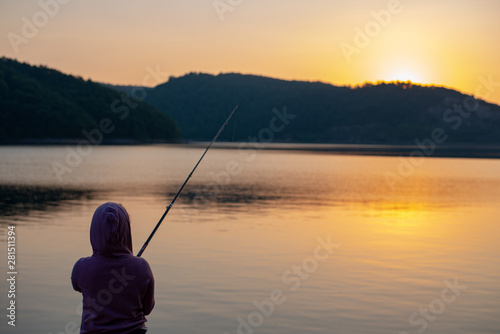 girl fishing by the lake