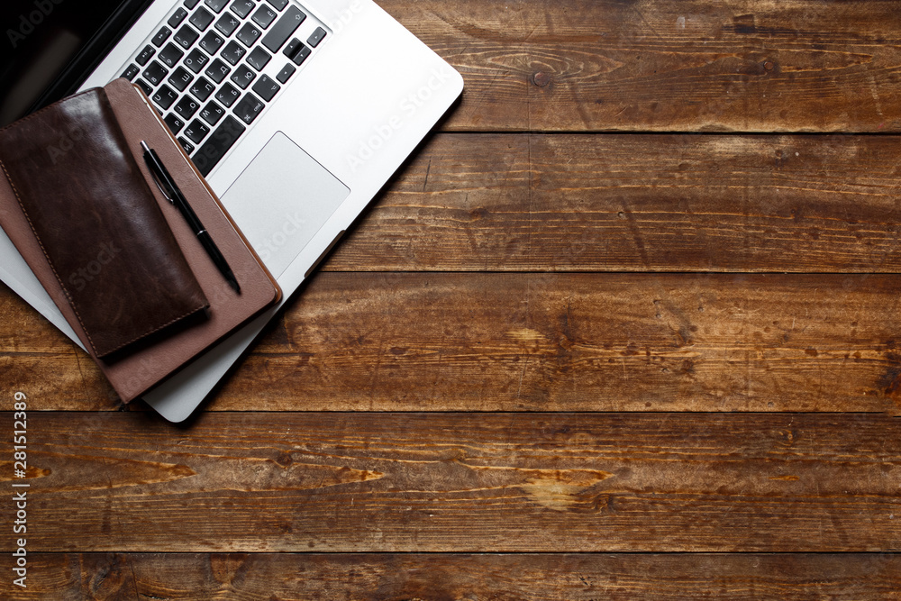 work space of a businessman. view from above . coffee notebook and laptop on the desktop with black note. work space of a businessman. view from above . coffee notebook and laptop on the desktop with black note.
