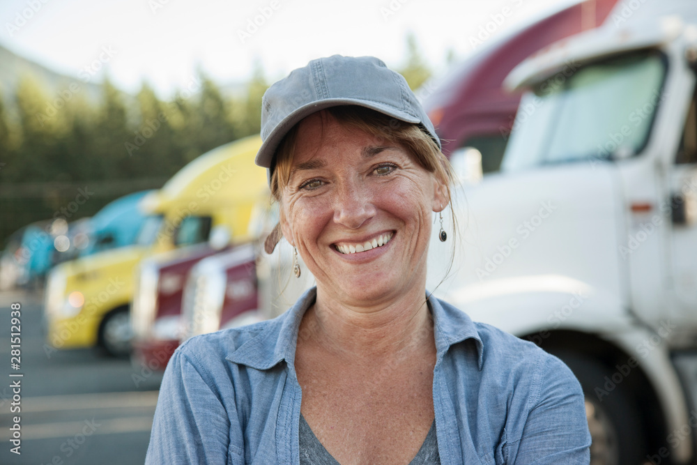 Portrait of smiling mature woman standing at truck stop Portrait of smiling mature woman standing at truck stop