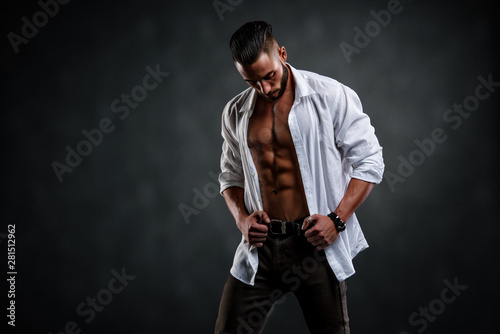 Handsome Male Model Wearing Unbuttoned White Shirt Exposing His Muscular Torso