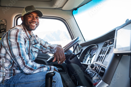 Portrait of truck driver sitting in truck photo