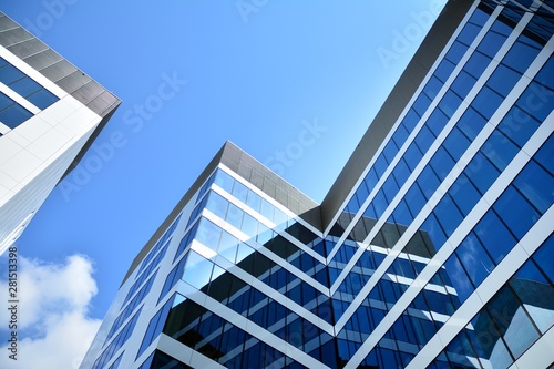 modern office building with blue sky and clouds