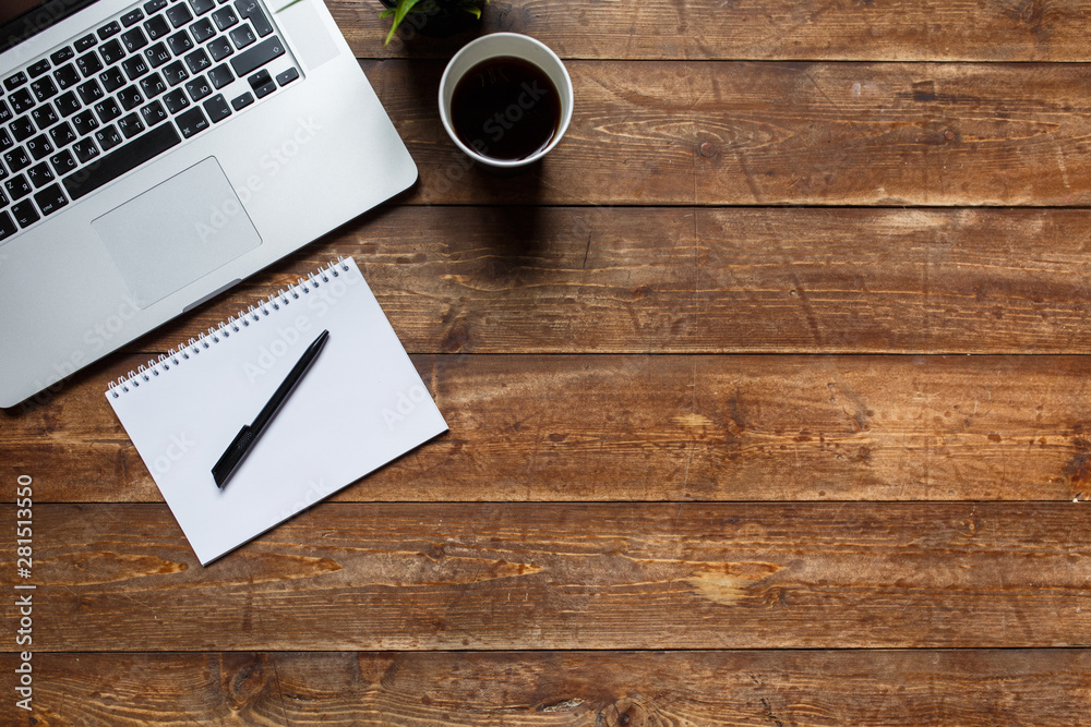 work space of a businessman. view from above . coffee black note and laptop on the desktop with black note. laptop on wooden background work space of a businessman. view from above . coffee black note and laptop on the desktop with black note. laptop on wooden background