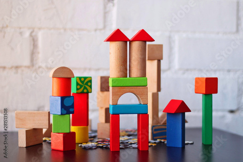 Construction made by a child of wooden building blocks of colors.