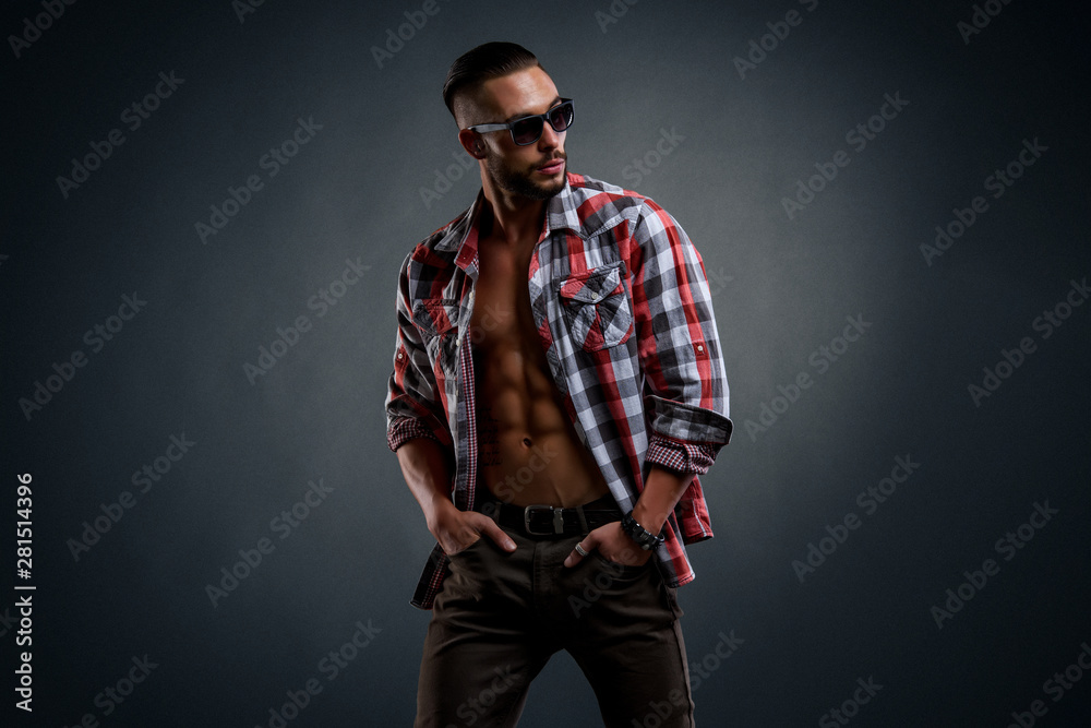 Handsome Male Model With Sunglasses Wearing Unbuttoned Shirt Exposing His Muscular Torso