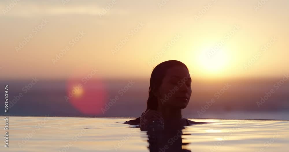 woman relaxing in swimming pool at luxury hotel spa enjoying beautiful ...