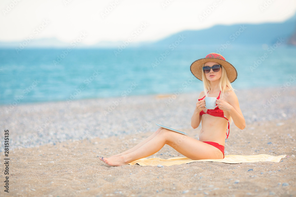 Pretty young girl sunbathing on the beach.