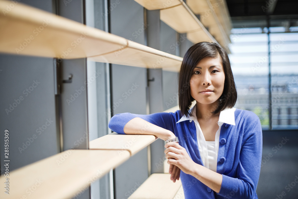 Portrait of businesswoman standing in office lobby Portrait of businesswoman standing in office lobby