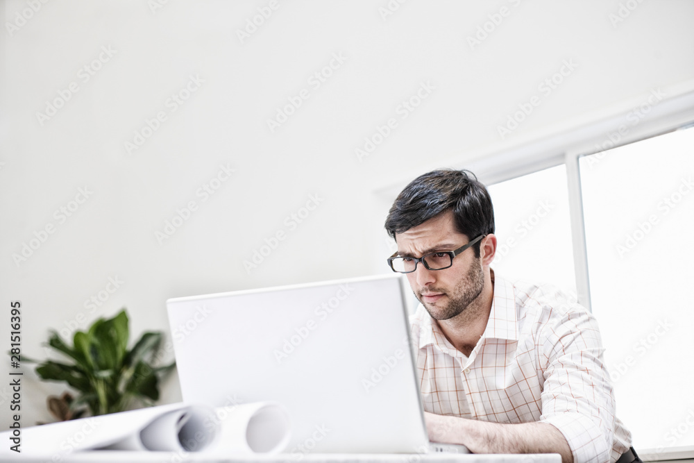 Man using laptop in office Man using laptop in office