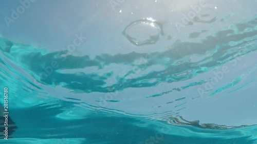 swimming pool underwater view of crystal clear water with bright sunlight shining on surface 4k footage