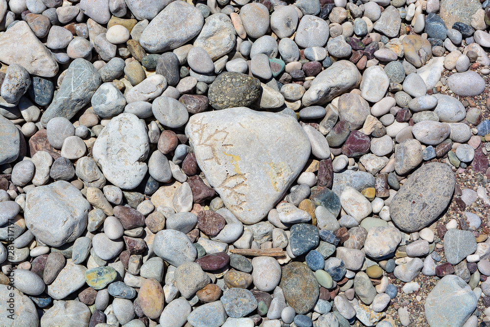 Many stones lie on the ground, pebble beach Many stones lie on the ground, pebble beach