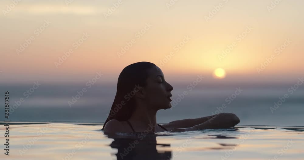 woman relaxing in swimming pool at luxury hotel spa enjoying beautiful ...