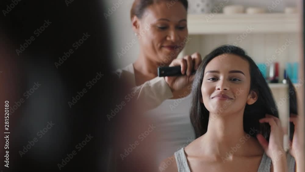 mother brushing daughters hair beautiful teenage girl getting ready looking at mirror in bathroom with mom helping with hairstyle 4k mother brushing daughters hair beautiful teenage girl getting ready looking at mirror in bathroom with mom helping with hairstyle 4k