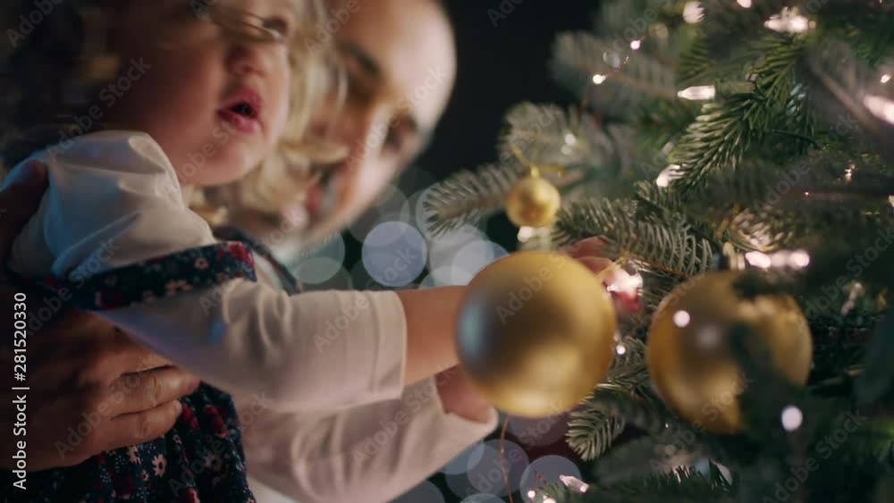little girl with father decorating christmas tree with beautiful ...