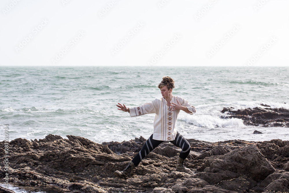 Young woman practicing martial art on seashore Young woman practicing martial art on seashore