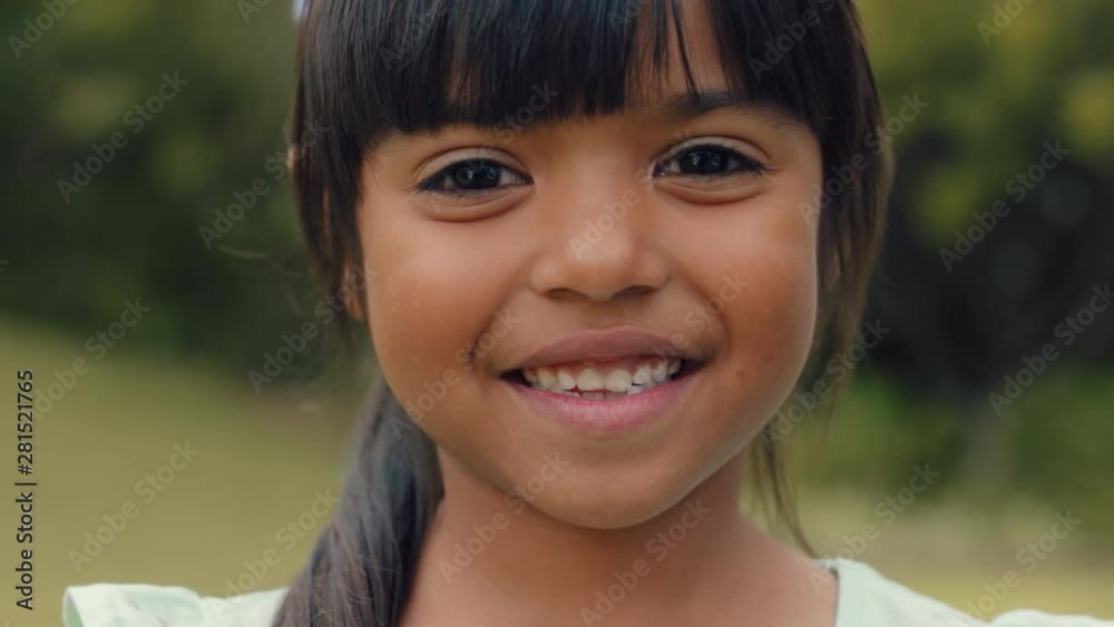 portrait beautiful little girl smiling looking happy cute child having fun in sunny park outdoors enjoying childhood testimonial concept 4k footage