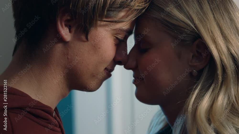 happy teenage couple first kiss girl kissing boyfriend at home after romantic evening date together 4k happy teenage couple first kiss girl kissing boyfriend at home after romantic evening date together 4k