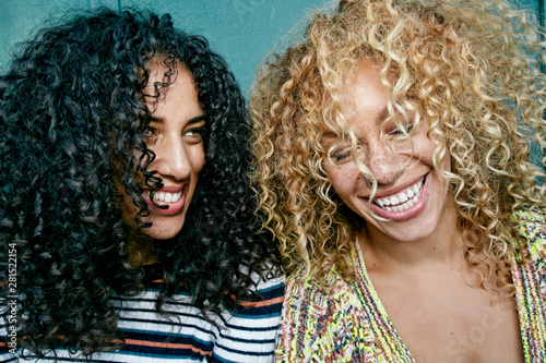 Close up of smiling young women in curly hair