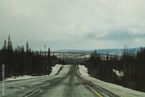Beautiful mountain landscape with long roadway. winter highway. car driving on a mountain road © maxkolmeto