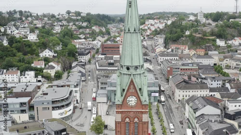 Beautiful aerial shot of the Trinity Church clocktower in Arendal. Slow tilt up.