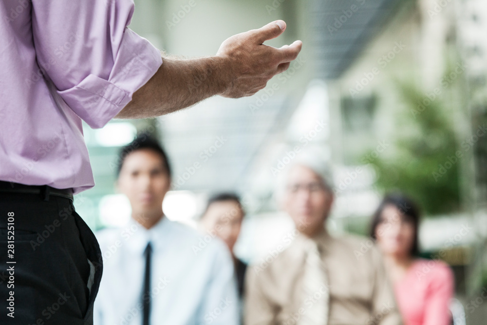 Businessman talking with colleagues in meeting Businessman talking with colleagues in meeting