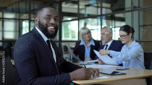 Wallpaper Mural Happy afro-american businessman smiling camera sitting office table, career Torontodigital.ca