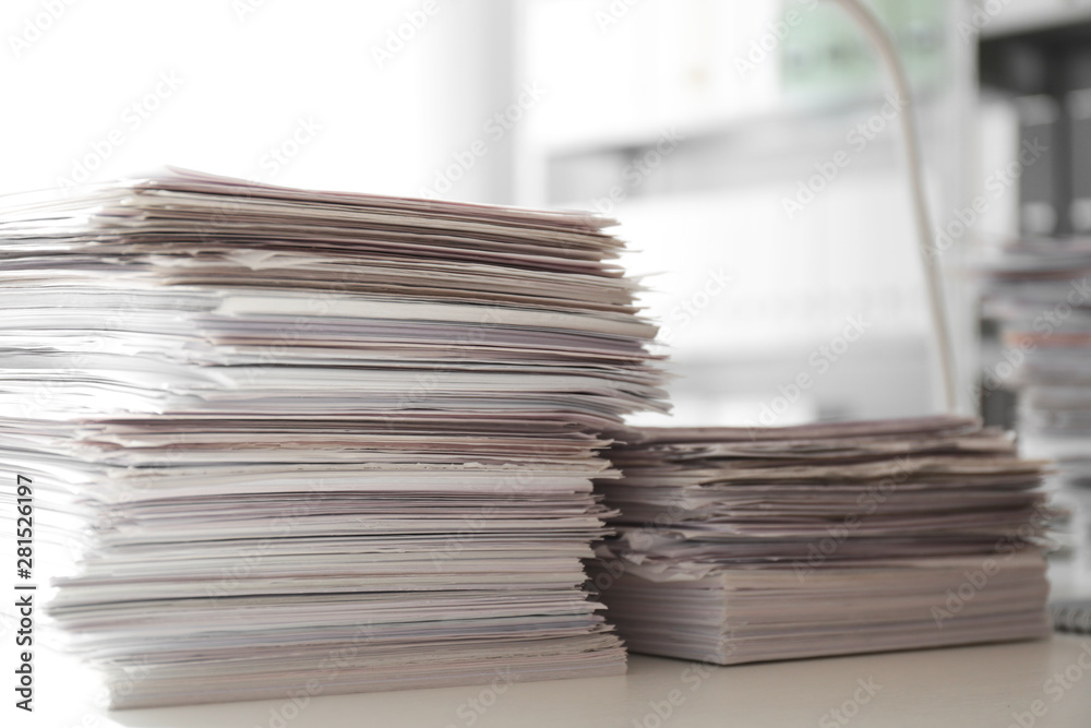 Stacks of documents on desk in office Stacks of documents on desk in office