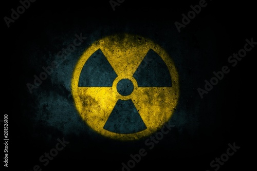 Fényképezés Nuclear energy radioactive (ionizing atomic radiation) round yellow symbol shape painted on massive concrete cement wall texture dark background