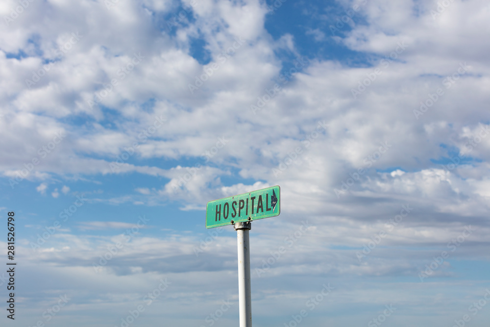 Rural hospital sign against cloudy sky Rural hospital sign against cloudy sky