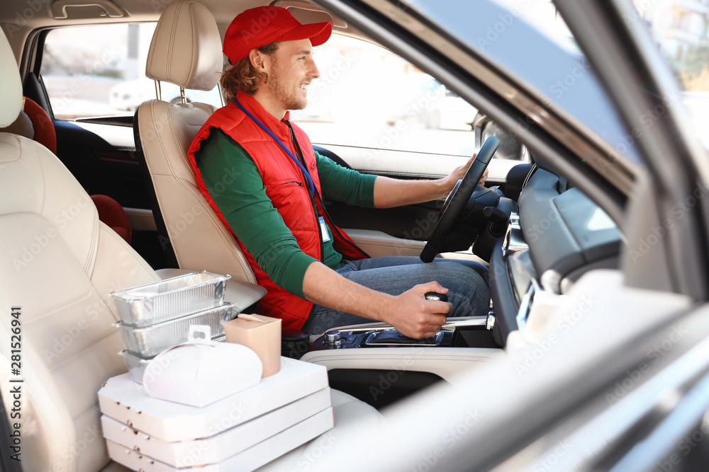 Male courier with orders in car. Food delivery service Stock Photo