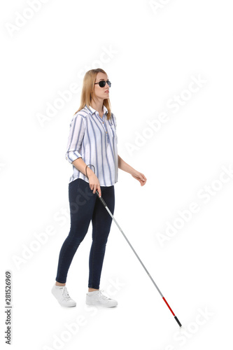 Blind woman in dark glasses with walking cane on white background