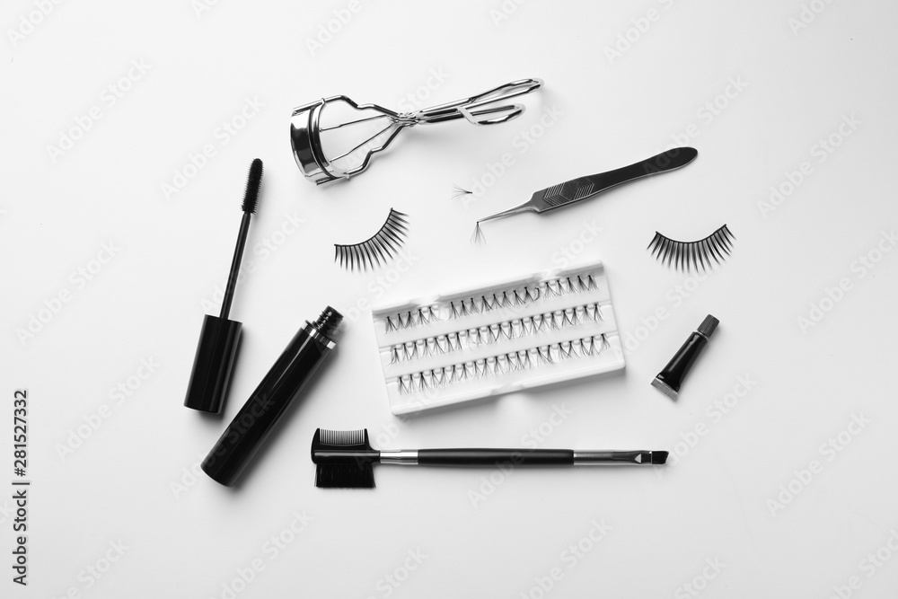 Naklejka premium Composition with false eyelashes and tools on white background, top view