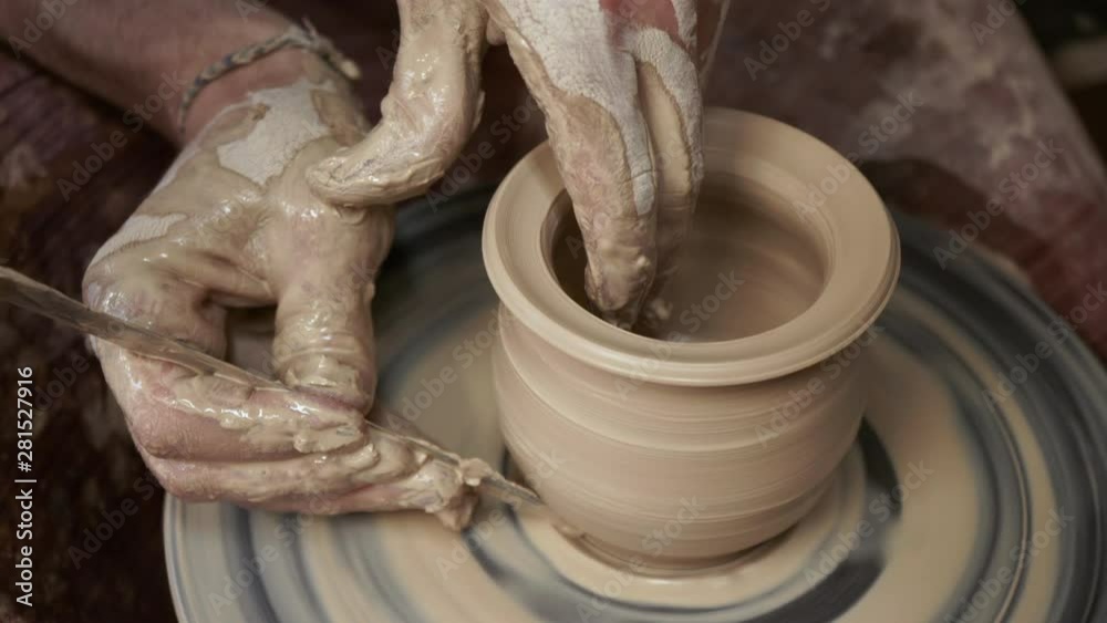 The potter makes a jug of clay. Ceramist. A man makes a vase on a ...