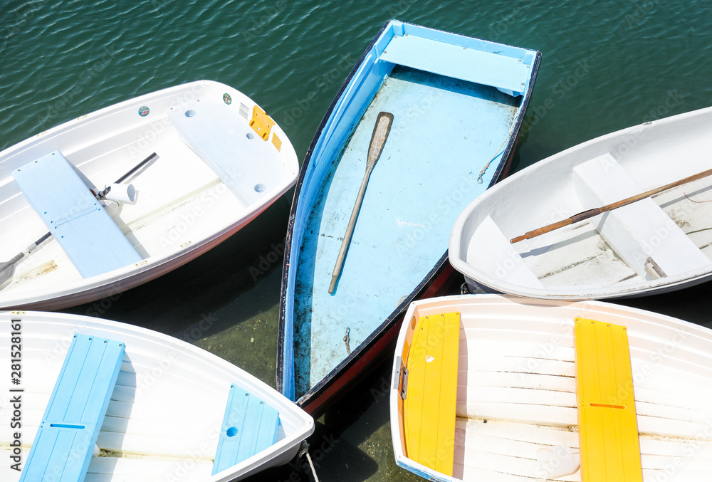 Colorful row boats or wooden dinghies parked at the dock. 