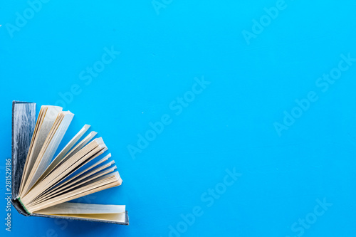 Books on library desk for reading and education on blue background top view mockup photo