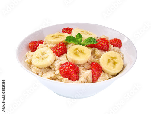Ceramic bowl of oatmeal porridge with banana and strawberry  isolated. Delicious and healthy food for breakfast.