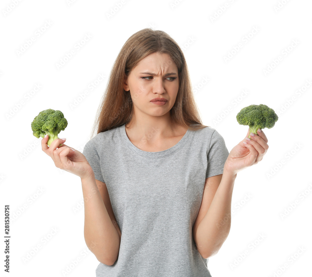 Portrait of unhappy woman with broccoli on white background Portrait of unhappy woman with broccoli on white background