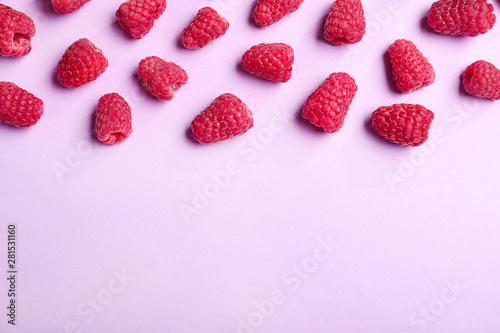 Tasty ripe juicy raspberries on pink background, top view with space for text