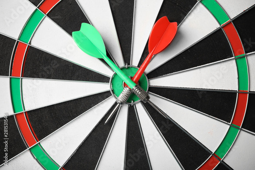 Red and green arrows on dart board, top view