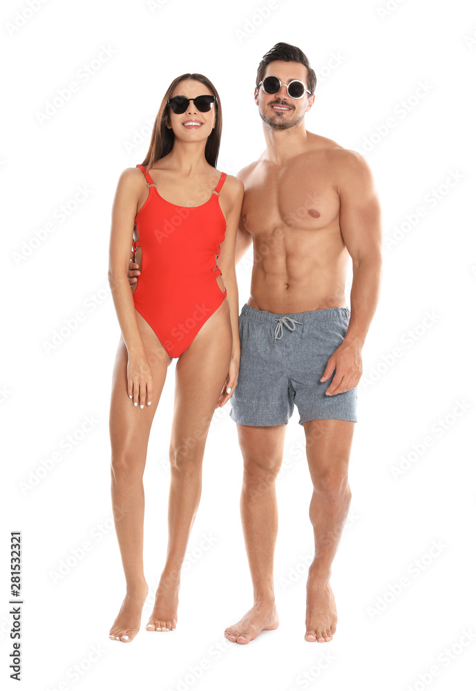 Young attractive couple in beachwear and sunglasses on white background Young attractive couple in beachwear and sunglasses on white background